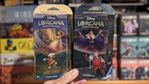 Jason holding two starter decks for Lorcana
