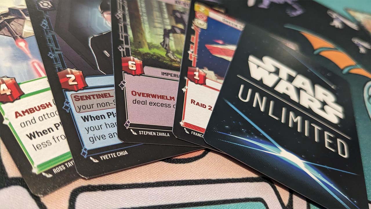 A selection of Star Wars Unlimited cards on the Card Gamer card mat.