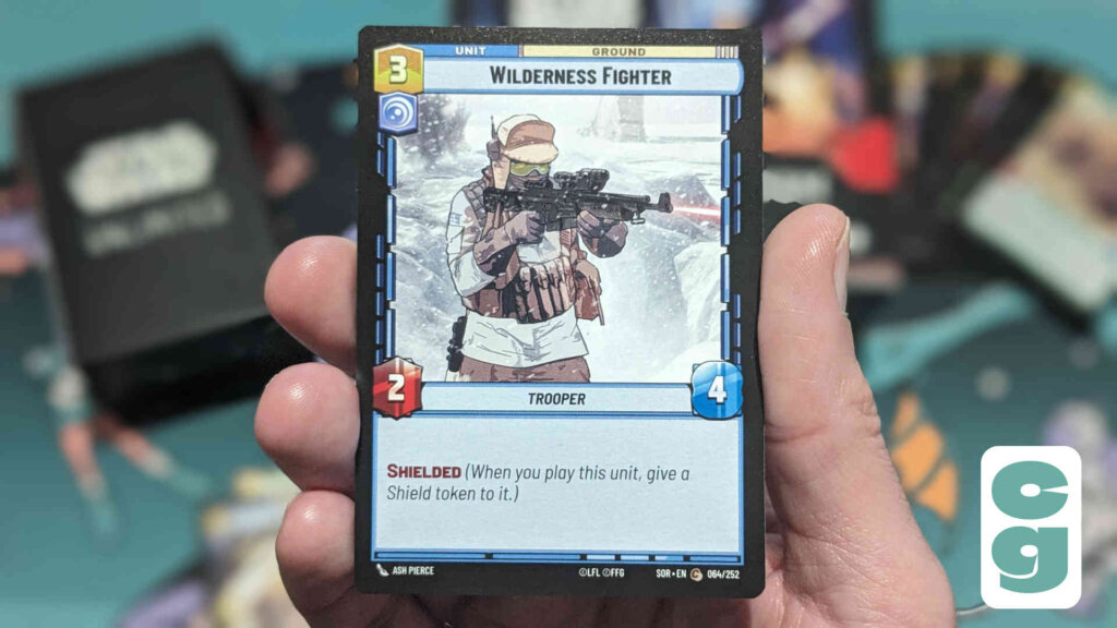 Card bearing the image of a Wilderness Fighter holding a gun. The card also explains what the keyword Shielded means.