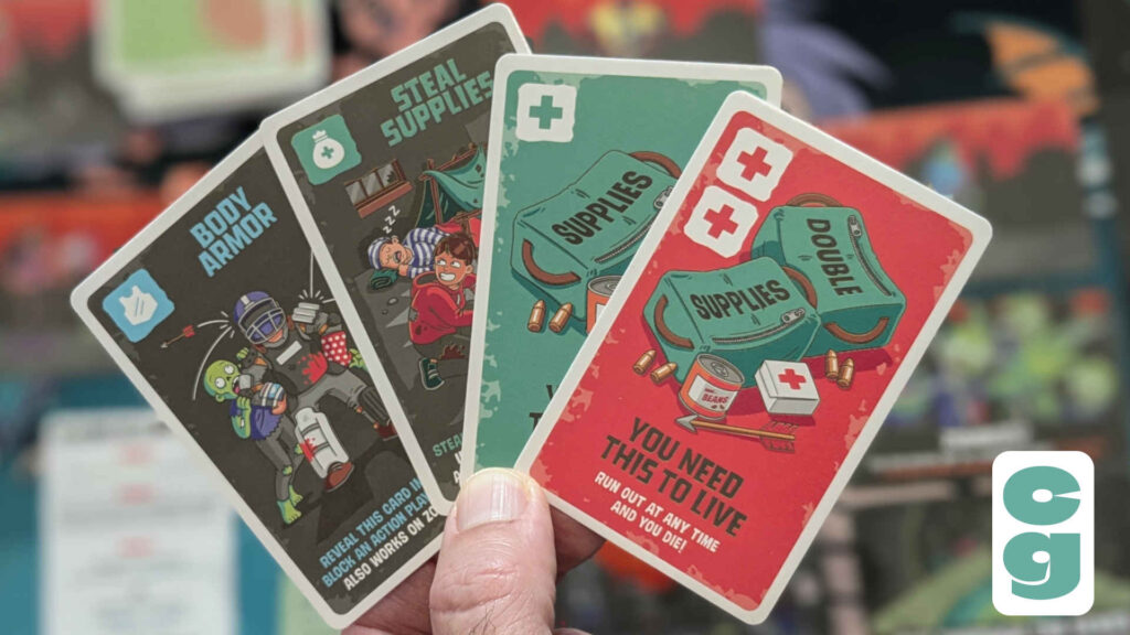 A hand displaying several cards for the A Little Selfish: Zombie Edition game.