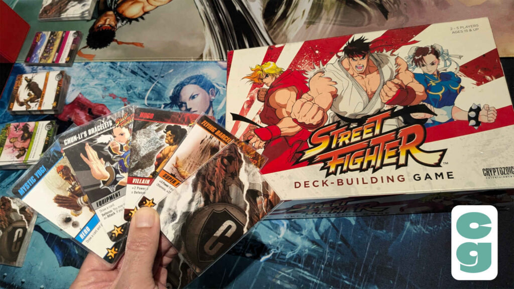 Street Fighter Deck-Building Game hand of cards, one showing the card back, and the box art