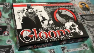 The Gloom Second Edition box surrounded by cards