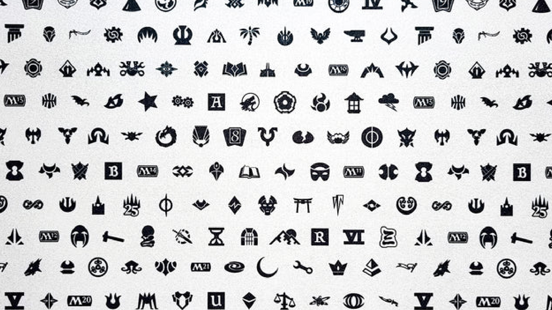A display of Magic: The Gathering set symbols from a playmat celebrating Magic's 30th Anniversary. Image credit: UltraPRO