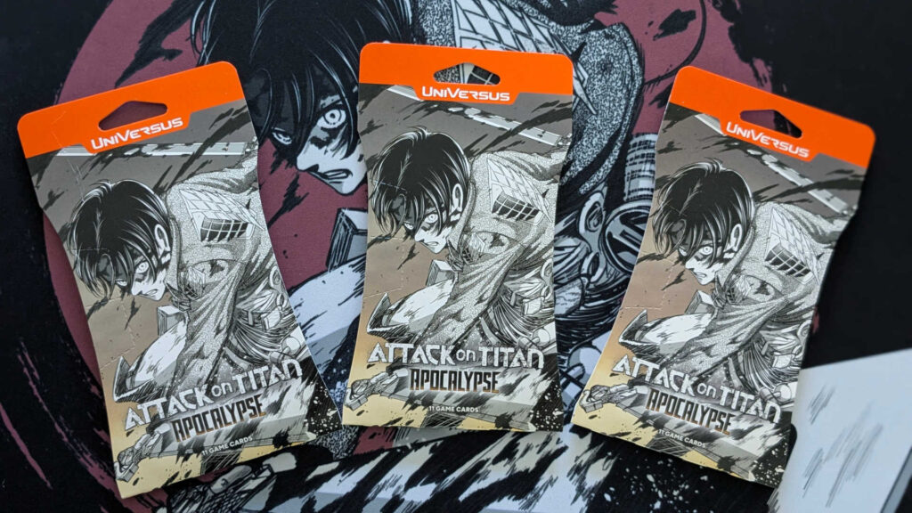 Three boosters and a playmat from Attack on Titan Apocalypse